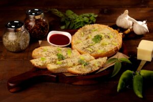 Garlic bread topped with herbs and melted cheese