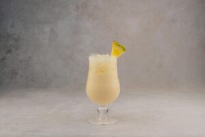 Creamy coconut rum cocktail with pineapple garnish