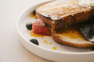 French toast slices served with fresh berries and maple syrup