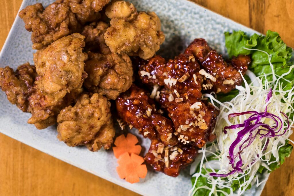 Honey garlic chicken thighs glazed in sticky sauce, served with fresh greens